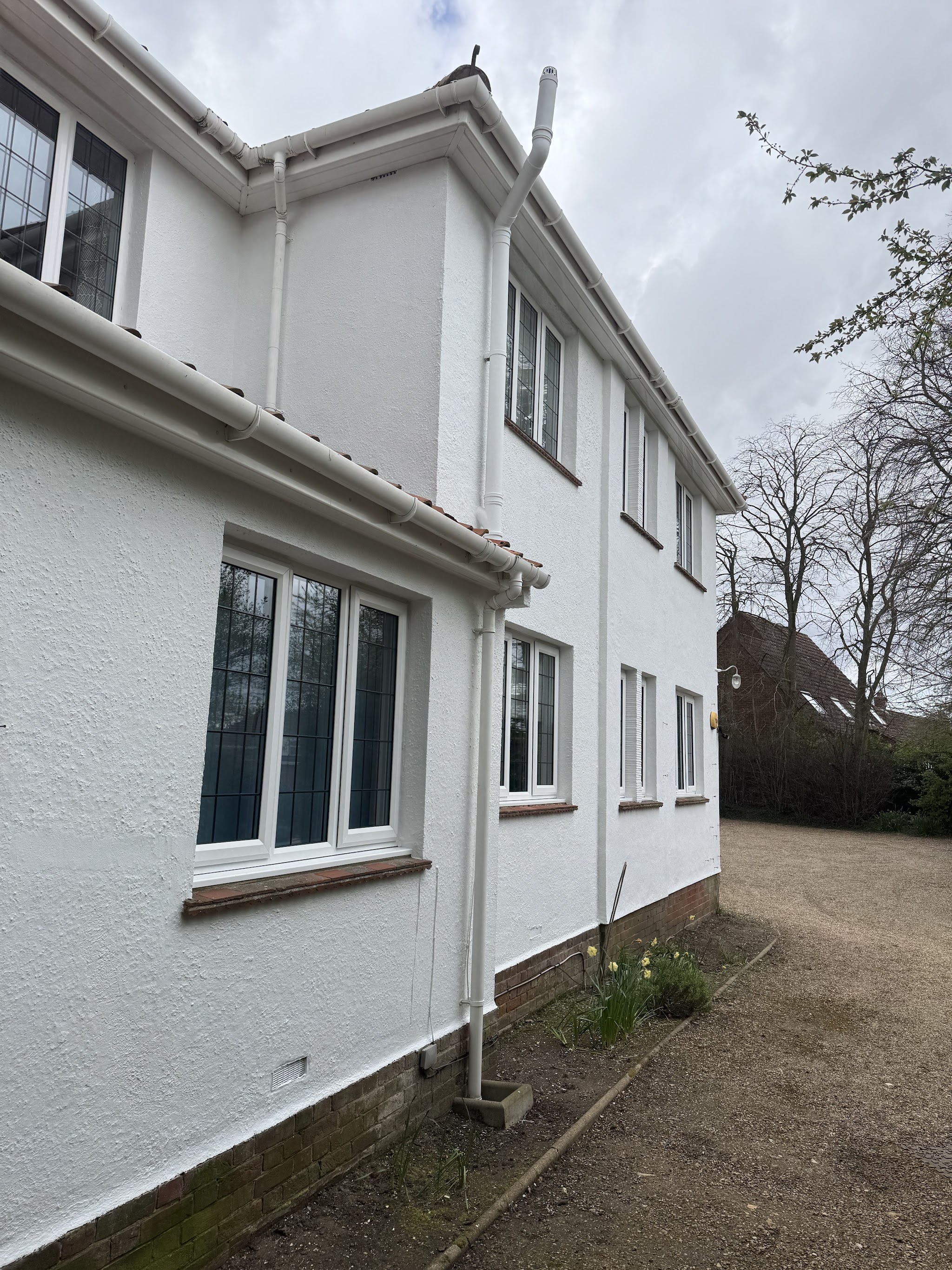 Side of a white rendered house after repainting