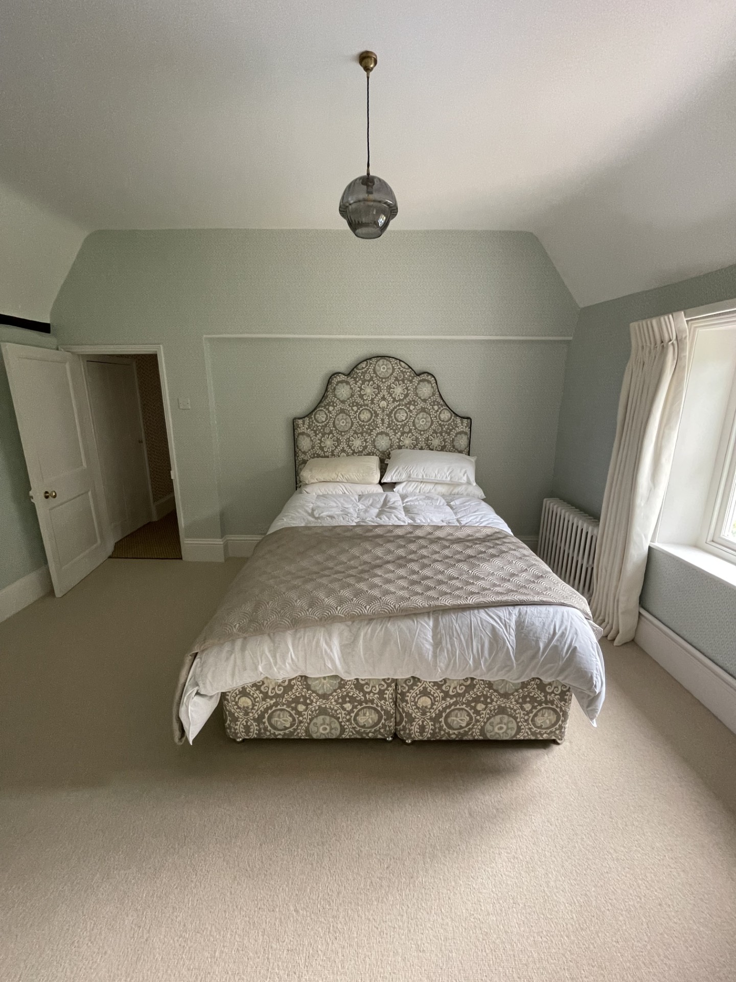 Bedroom decorated in a soft green grey
