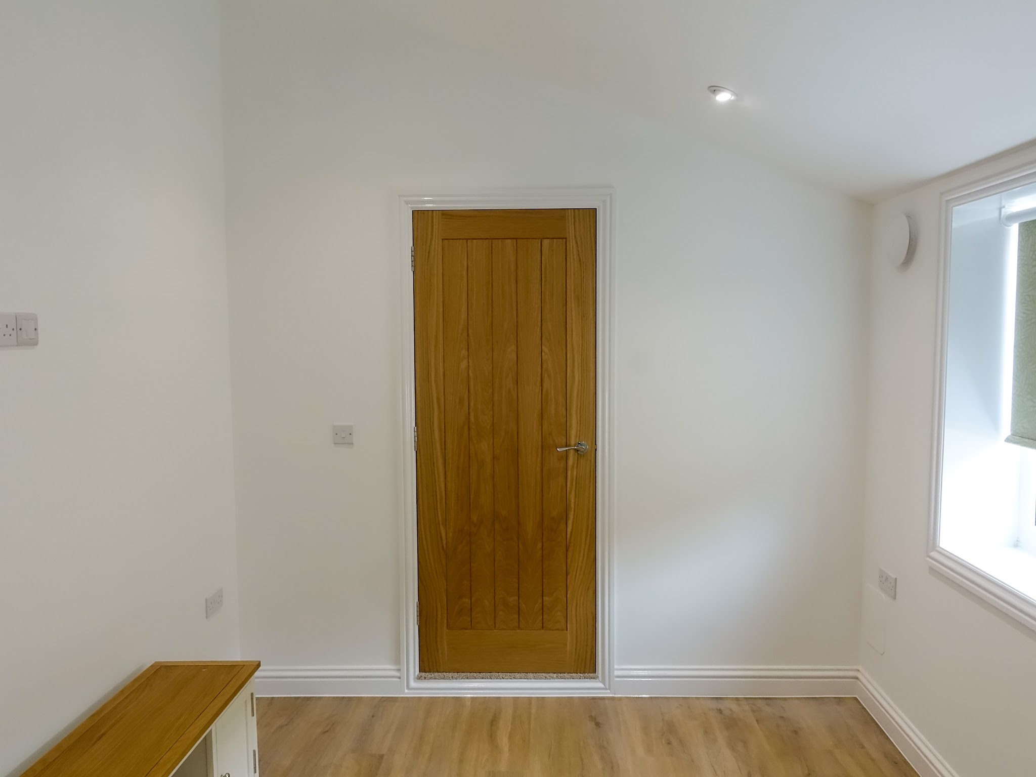 Freshly painted room with an oak door
